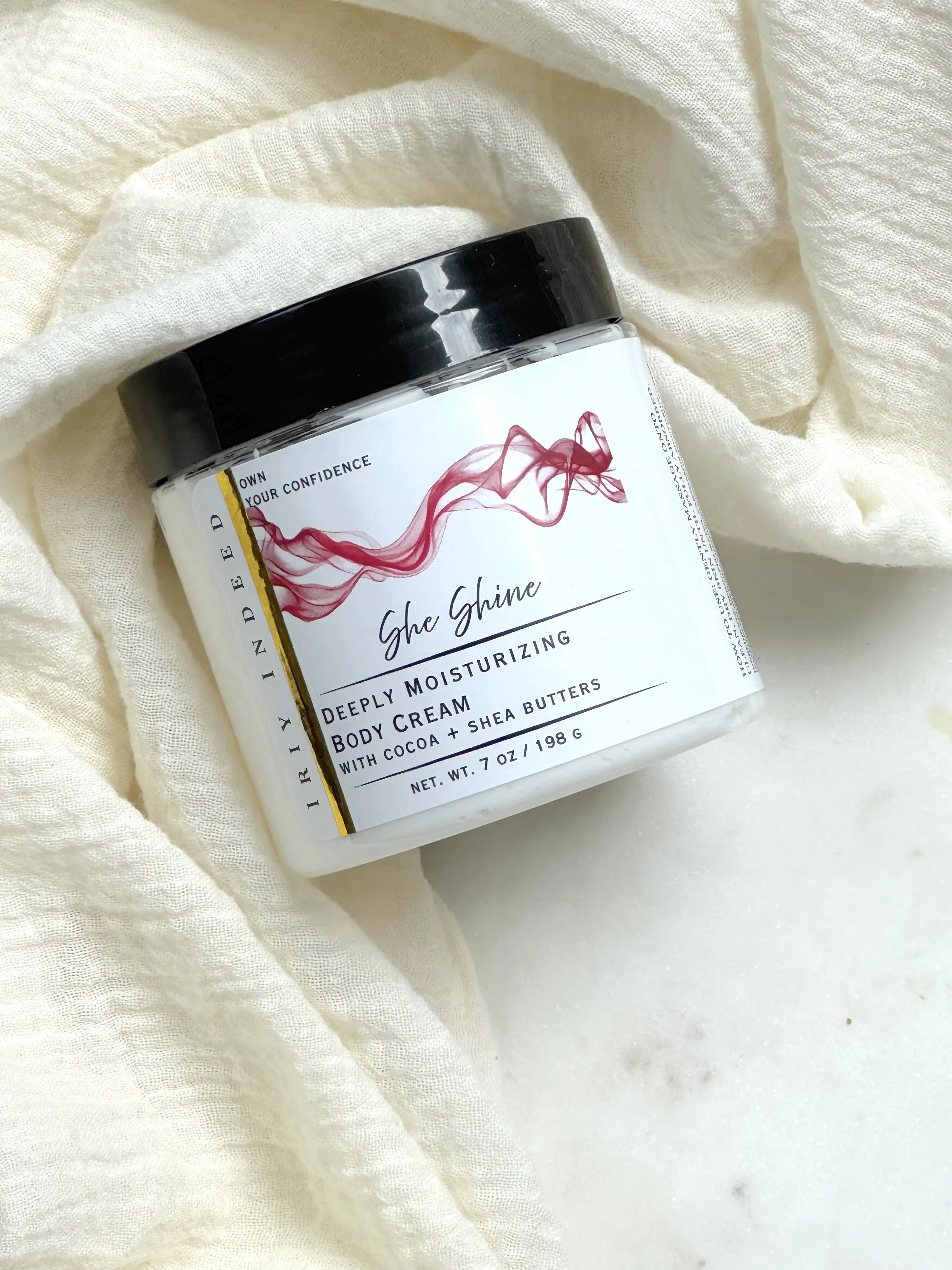 Image of clear cream jar with black lid 