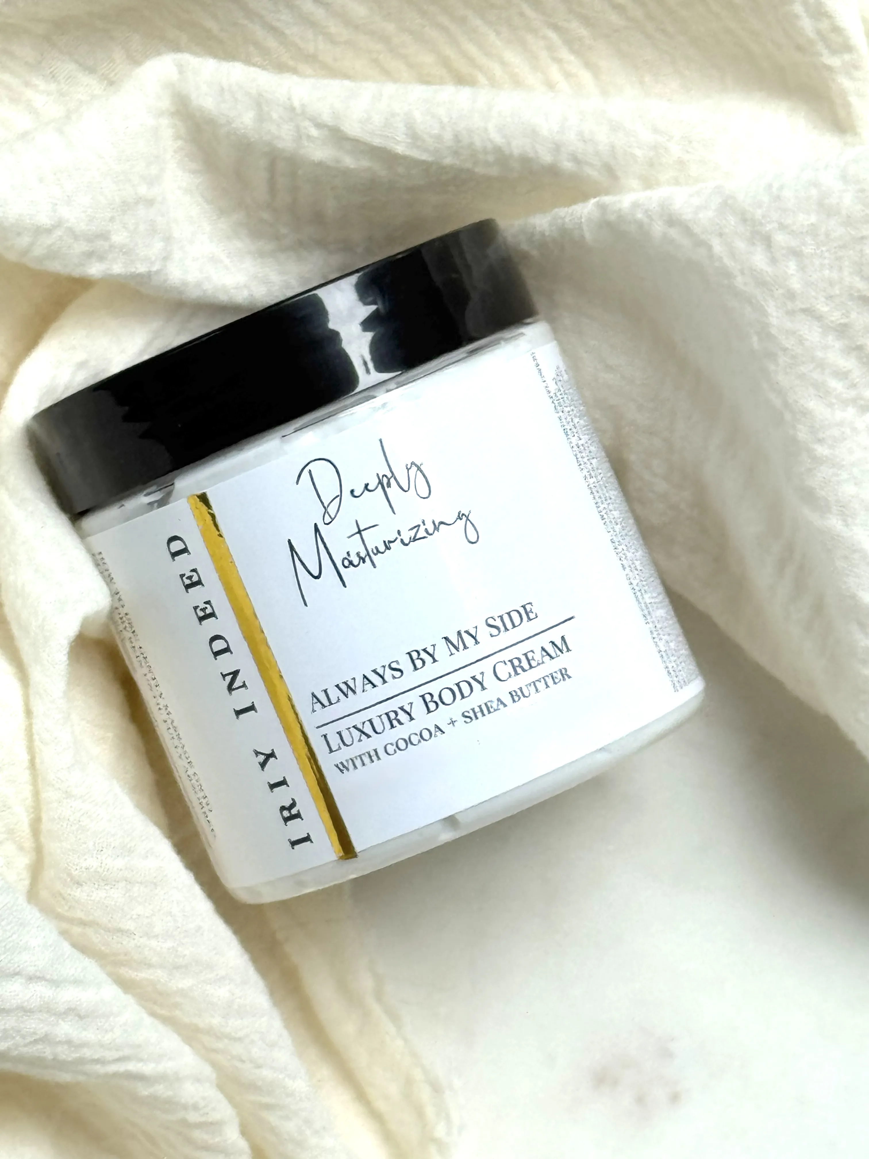 Image shows cream jar with white label and black lid