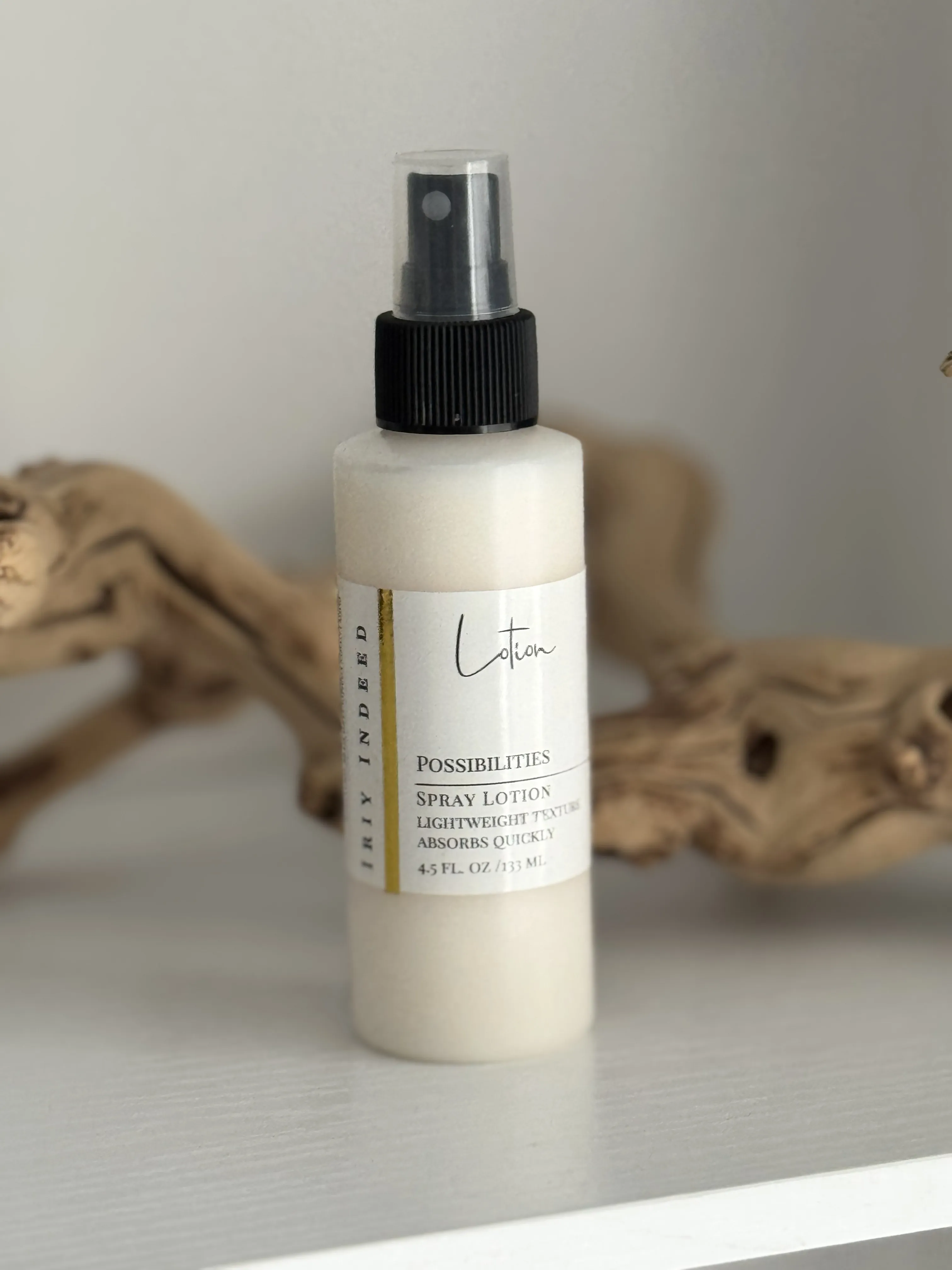 white spray lotion bottle with black spray top