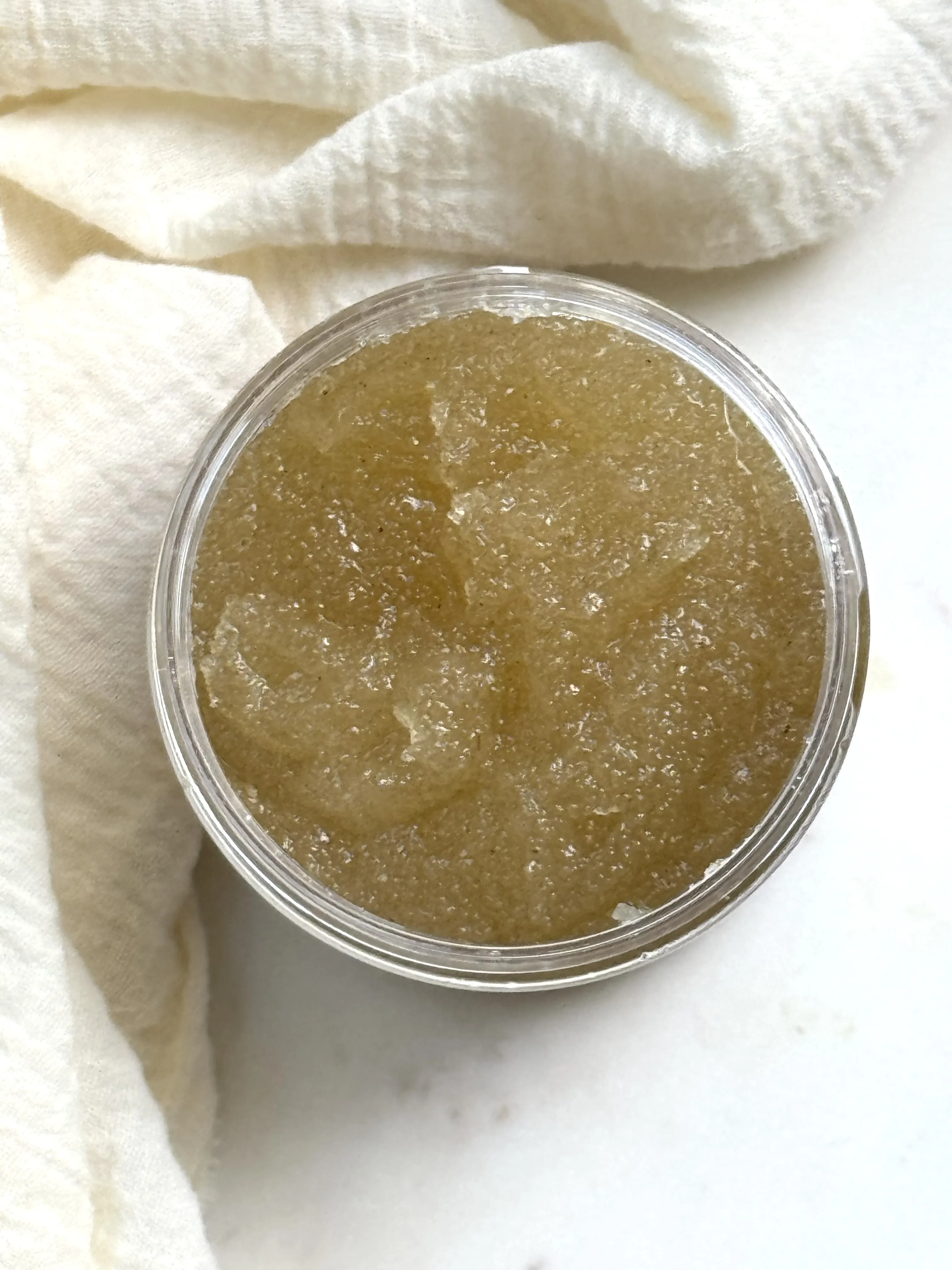an open jar with sugar scrub inside