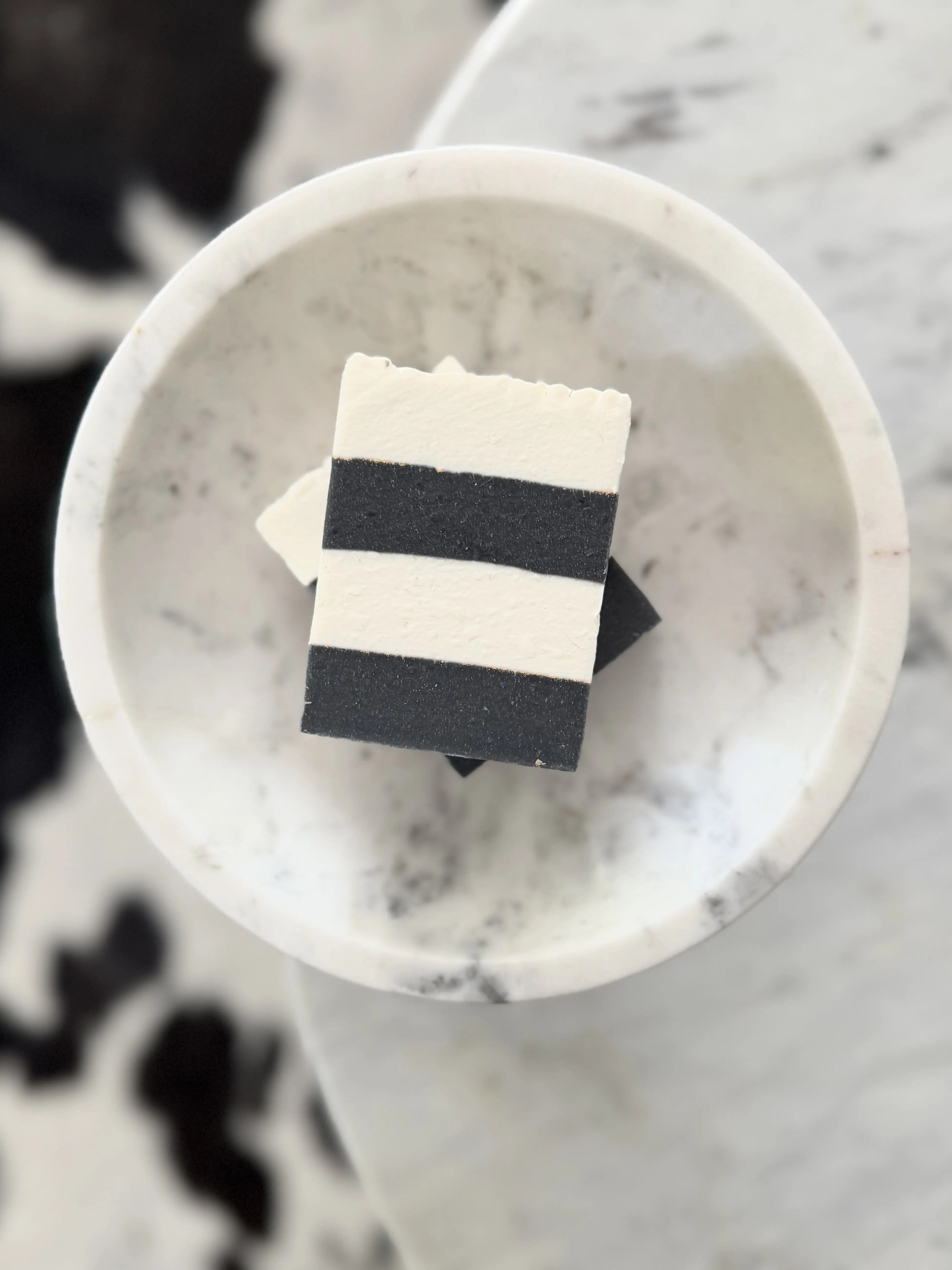 black and white striped soap in marble bowl	